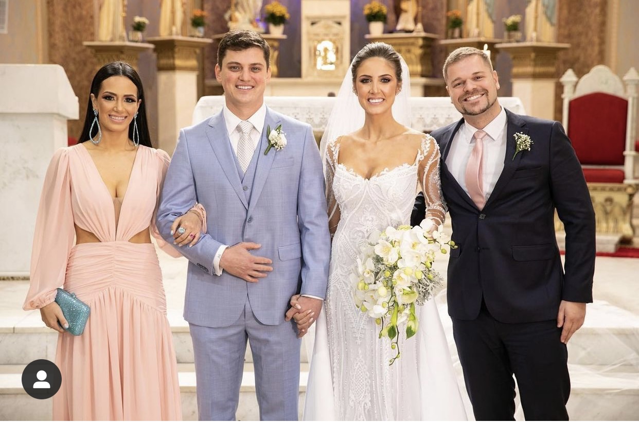 Os noivos Escarlaty Marques e Júlio Cechinel, celebrando a união com linda cerimônia na Igreja Nossa Senhora Conceição em Urussanga, emoldurados pelos padrinhos Manuela Salvan e o dentista Mauricio Costa.