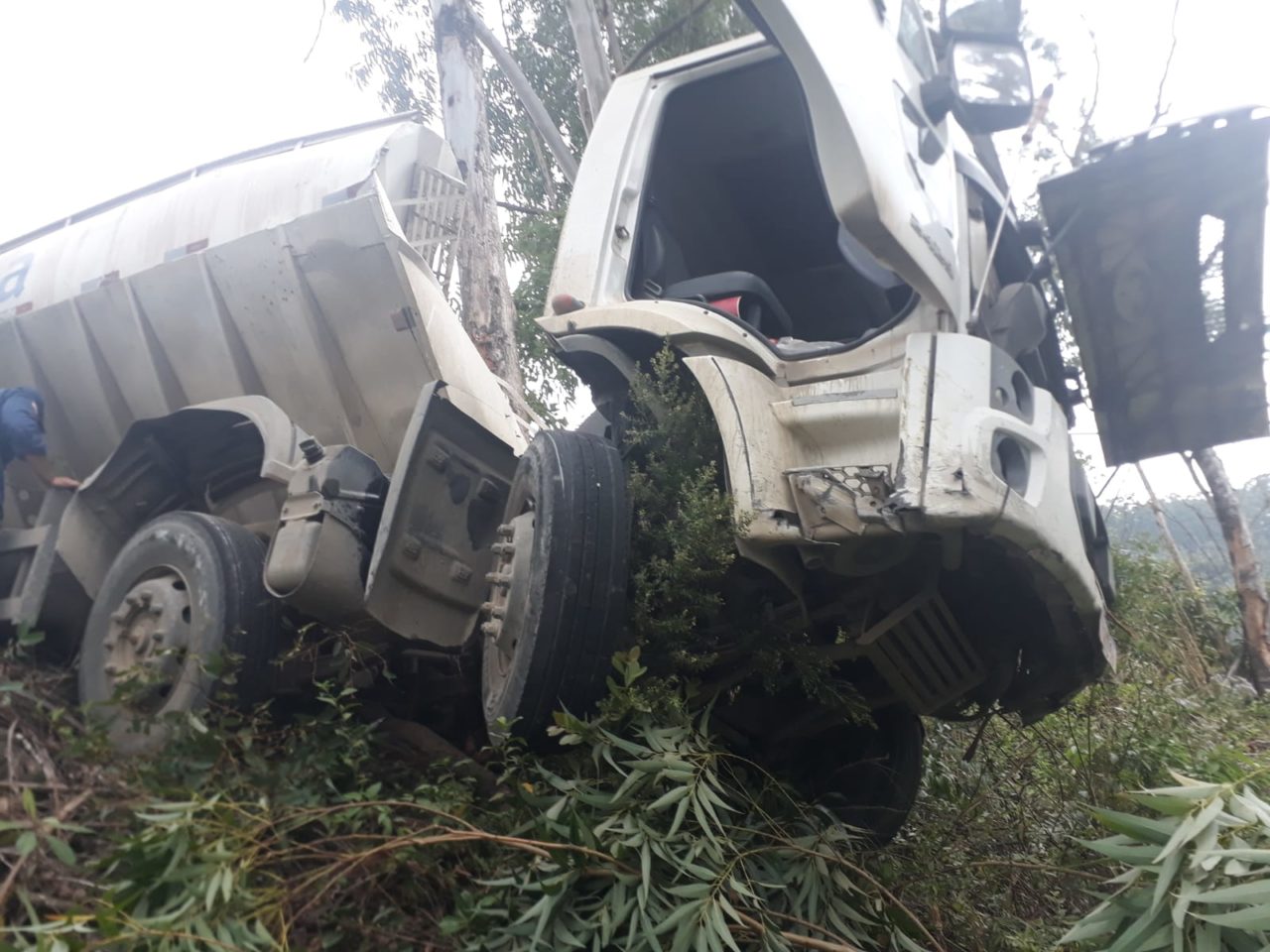 Caminhão fica pendurado em ribanceira após saída de pista